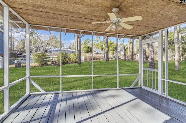 unfurnished sunroom with ceiling fan