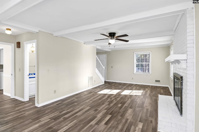 unfurnished living room with dark wood-type flooring, ceiling fan, a fireplace, and beamed ceiling