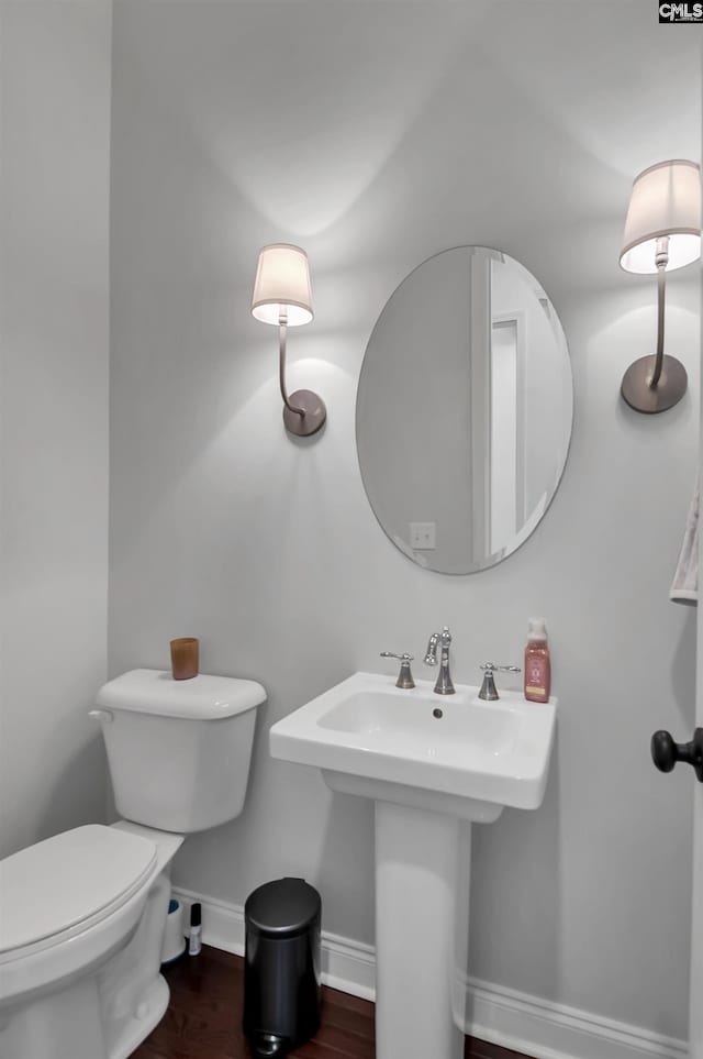 bathroom featuring hardwood / wood-style floors, sink, and toilet