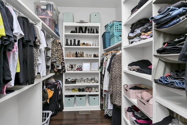 spacious closet with dark hardwood / wood-style floors