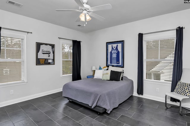 tiled bedroom featuring ceiling fan