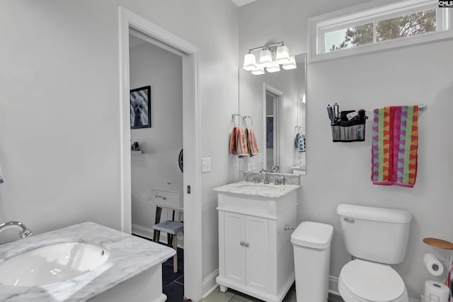 bathroom with vanity, toilet, and tile patterned flooring