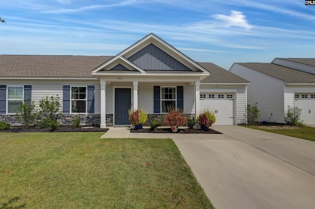 view of front of property with a porch, a garage, and a front yard