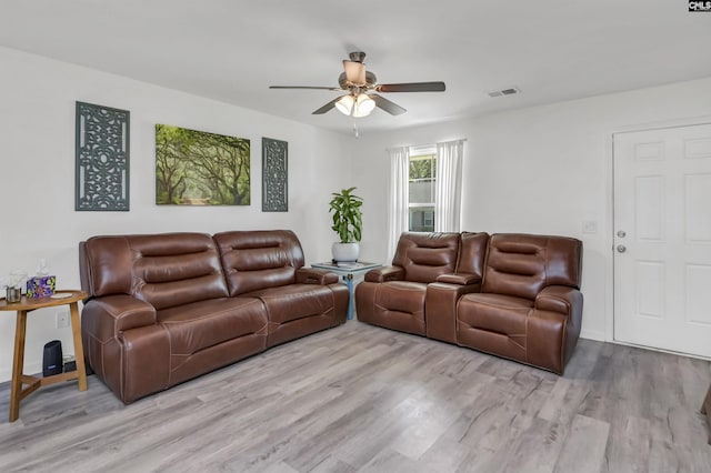 living room featuring light hardwood / wood-style floors and ceiling fan