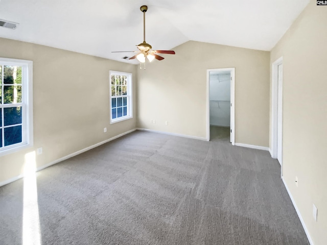 carpeted spare room with vaulted ceiling and ceiling fan