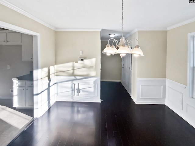 unfurnished dining area with crown molding, a chandelier, and dark hardwood / wood-style flooring