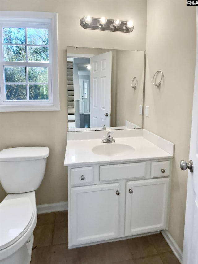 bathroom featuring vanity, tile patterned floors, and toilet