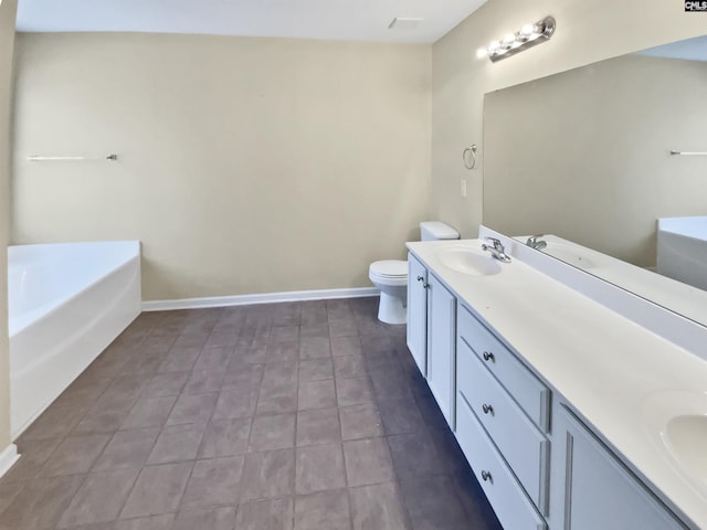 bathroom with vanity, toilet, and a tub to relax in