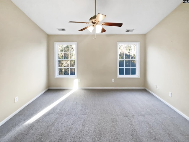 carpeted spare room with ceiling fan