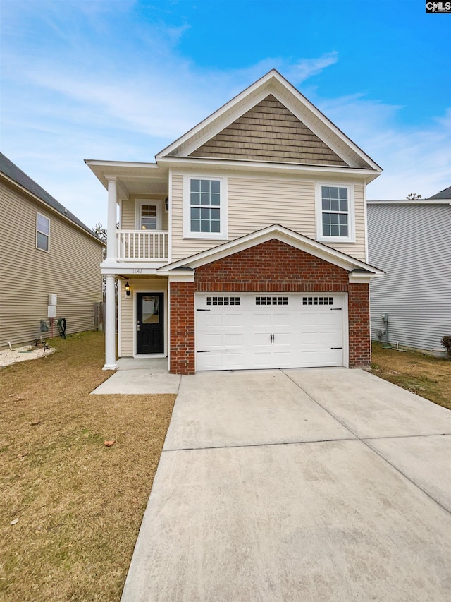 view of front of home with a balcony, a garage, and a front yard