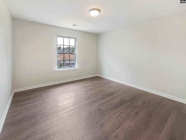 spare room featuring dark hardwood / wood-style flooring