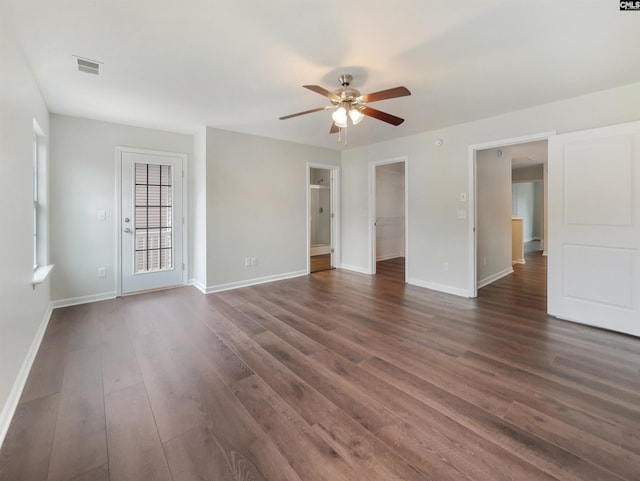 unfurnished room featuring dark wood-type flooring and ceiling fan