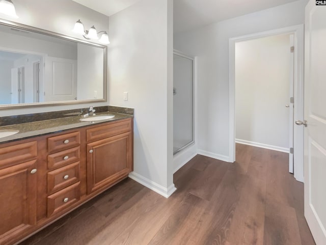 bathroom featuring a shower with door, vanity, and hardwood / wood-style floors