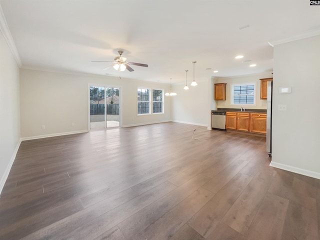 unfurnished living room featuring ornamental molding, plenty of natural light, dark hardwood / wood-style floors, and ceiling fan