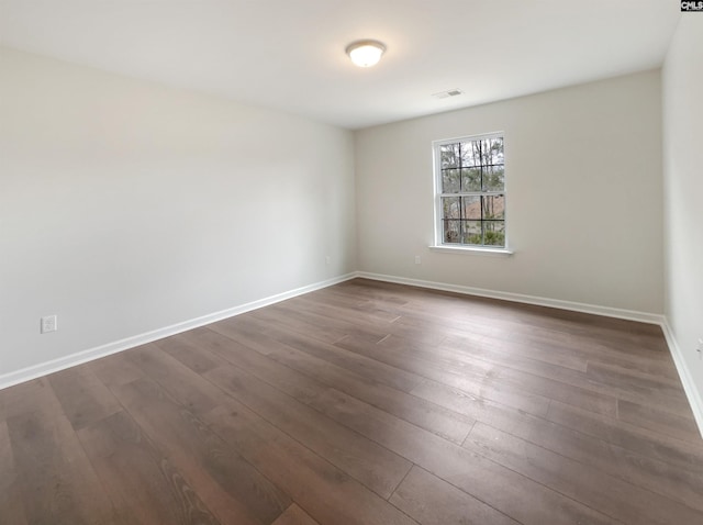 unfurnished room with dark hardwood / wood-style floors