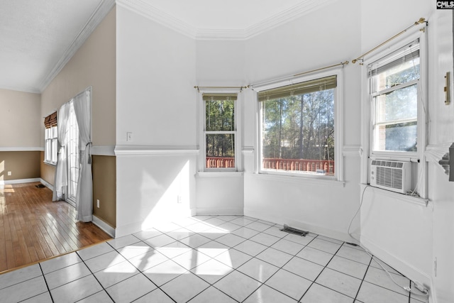 unfurnished room featuring light tile patterned flooring, crown molding, and cooling unit