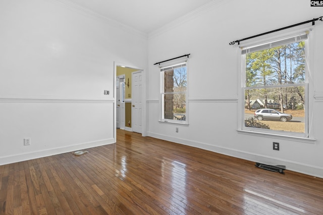 empty room featuring hardwood / wood-style flooring and crown molding