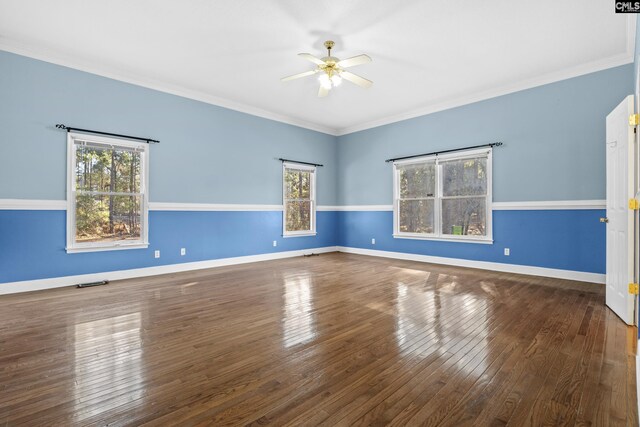 spare room featuring ceiling fan, ornamental molding, and dark hardwood / wood-style floors