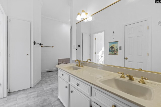 bathroom with vanity, crown molding, and tile patterned floors