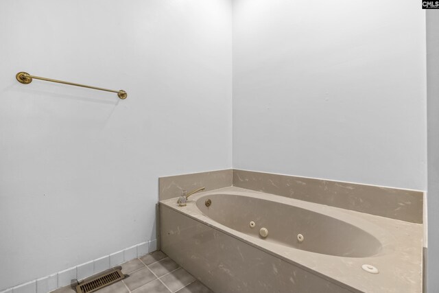 bathroom with tile patterned flooring and a bathing tub