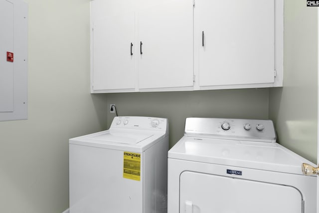 laundry room featuring cabinets, electric panel, and washing machine and dryer