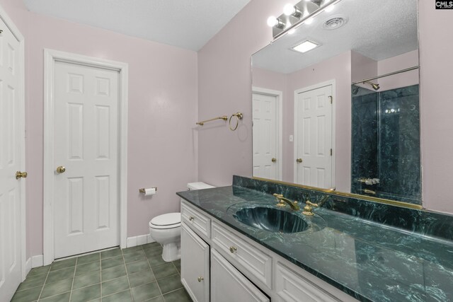 bathroom featuring vanity, walk in shower, toilet, tile patterned floors, and a textured ceiling