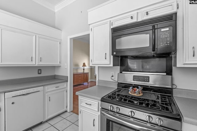 kitchen with light tile patterned flooring, stainless steel gas range, white cabinetry, crown molding, and dishwasher