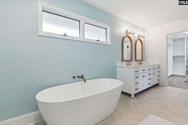 bathroom with vanity, parquet flooring, and a bathing tub