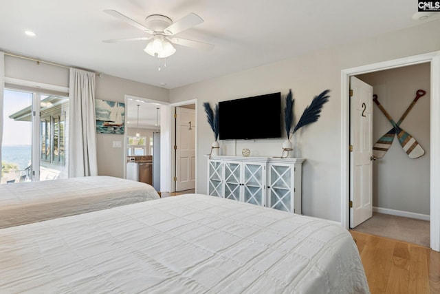 bedroom featuring hardwood / wood-style flooring, access to exterior, and ceiling fan