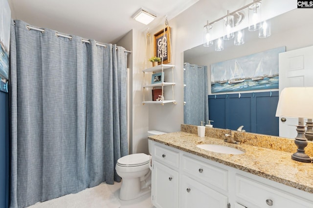 bathroom with vanity, tile patterned floors, and toilet