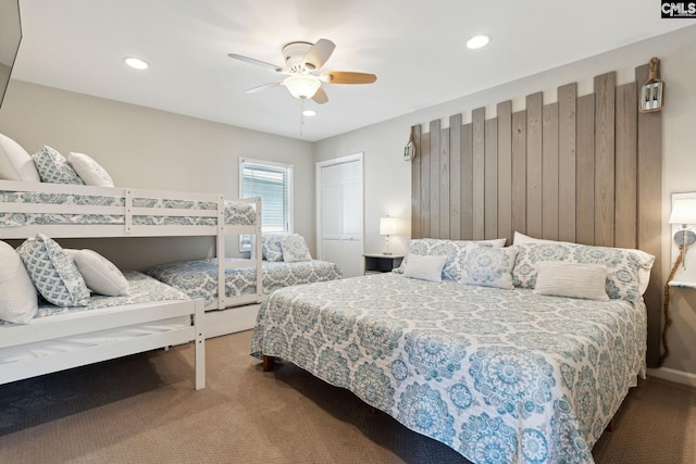 carpeted bedroom with ceiling fan and a closet