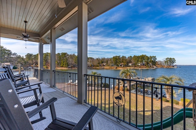 balcony with a water view and ceiling fan