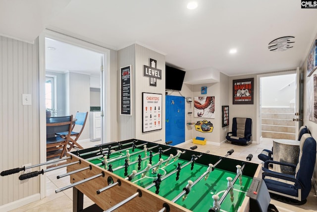 rec room featuring tile patterned flooring and crown molding