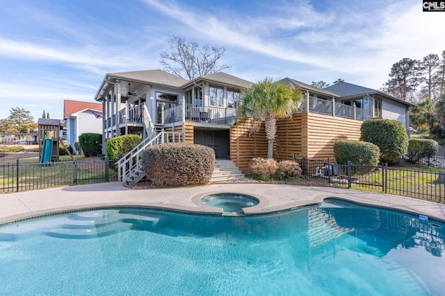 view of pool with an in ground hot tub