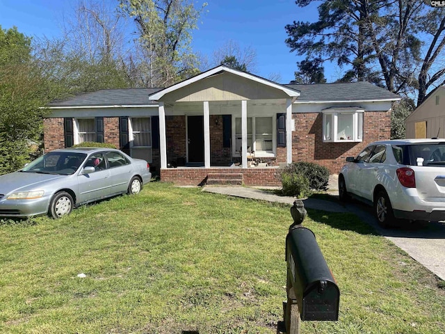 view of front of house with a front yard and covered porch