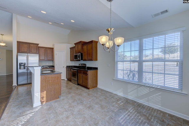 kitchen with pendant lighting, a breakfast bar area, a chandelier, a kitchen island with sink, and stainless steel appliances