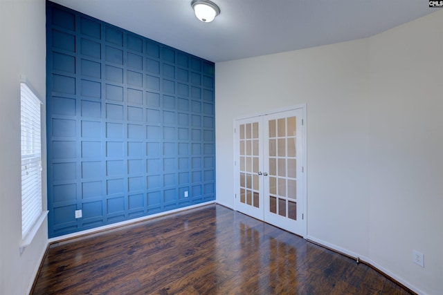 unfurnished room with dark hardwood / wood-style floors, plenty of natural light, and french doors