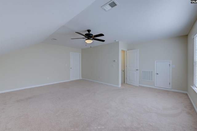 bonus room with vaulted ceiling, light colored carpet, and ceiling fan