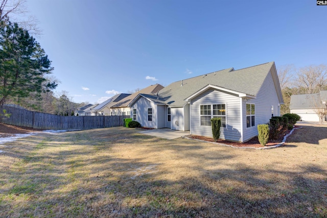 back of property with a patio and a lawn