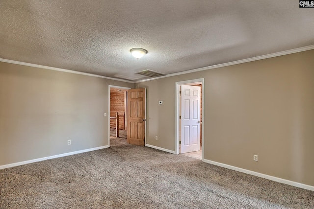 carpeted empty room with crown molding and a textured ceiling