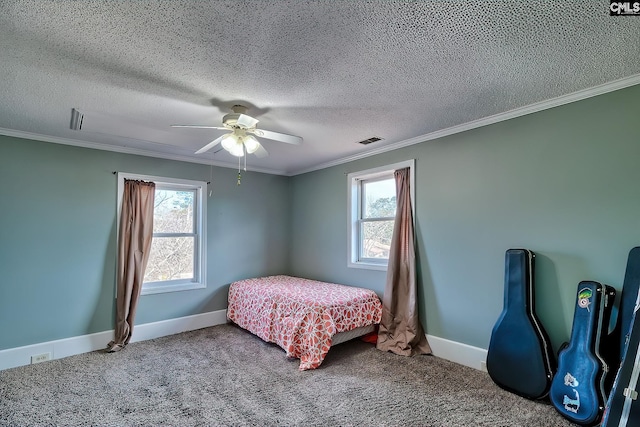 bedroom featuring ornamental molding, ceiling fan, and carpet