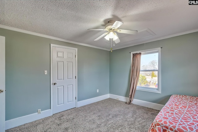 unfurnished bedroom with crown molding, carpet floors, a textured ceiling, and ceiling fan