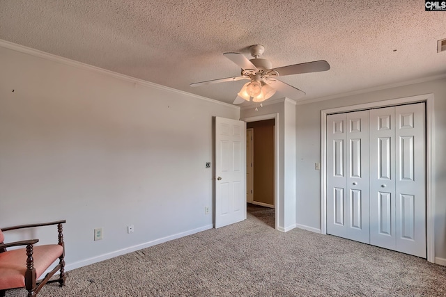 unfurnished bedroom with carpet flooring, a textured ceiling, and ceiling fan