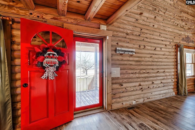 entryway with wood ceiling, log walls, and beam ceiling