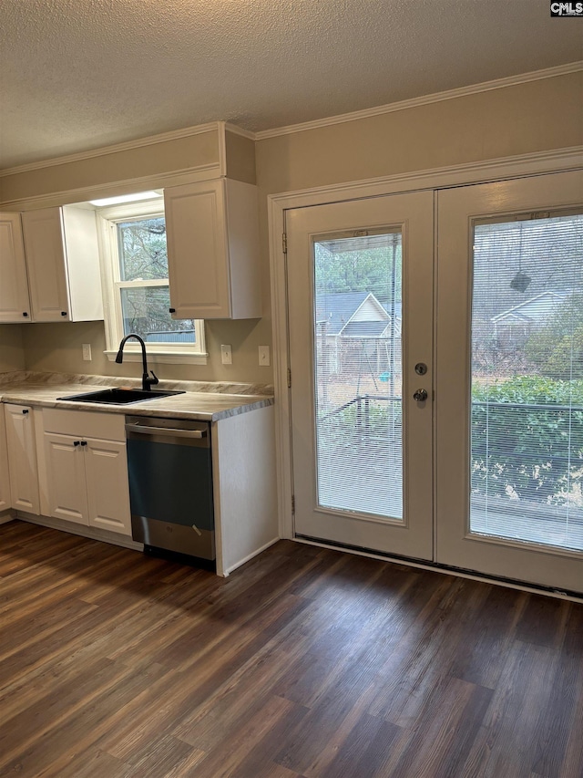 kitchen with white cabinetry, dishwasher, a textured ceiling, and a wealth of natural light