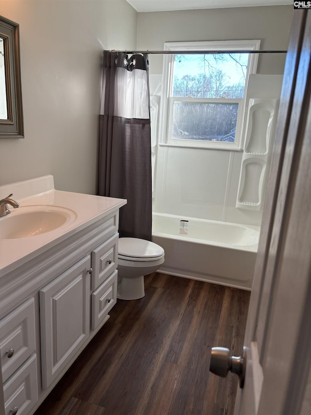 full bathroom with vanity, toilet, wood-type flooring, and shower / bath combo with shower curtain