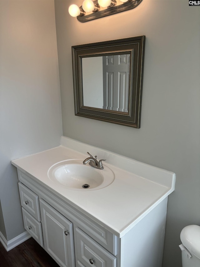 bathroom featuring hardwood / wood-style flooring, vanity, and toilet