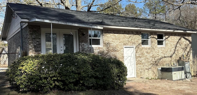 view of side of home with central AC unit