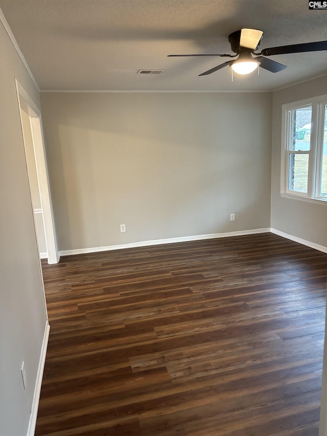 spare room featuring dark wood-type flooring, ornamental molding, and ceiling fan