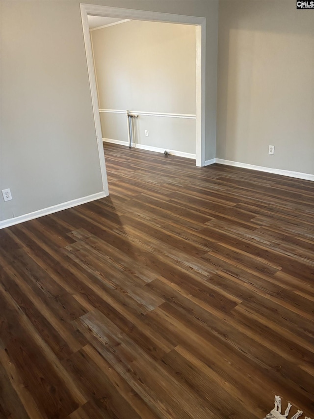 unfurnished room with dark hardwood / wood-style floors